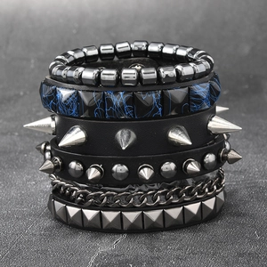 Macro detail of multi-layer punk bracelet set with metal studs and black leather