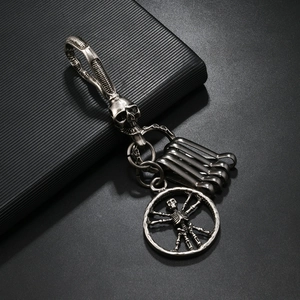 Gothic silver skeleton keychain with rotating skull hook and circular skeletal pendant