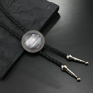 Detailed close-up of Bolo Tie featuring a purple gemstone and braided leather cord
