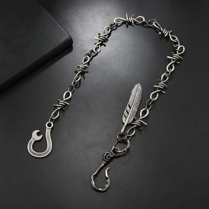 Detail of retro silver barbed wire chain with feather pendant and wrench hook closure