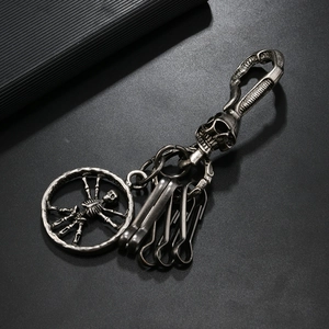 Close-up of vintage punk skeleton metal keychain with antique silver finish and U-hooks
