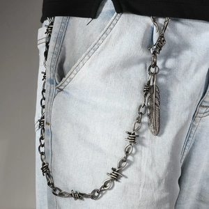 Hip-hop streetwear silver thorn chain with feather pendant on light blue jeans