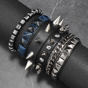 Detail of multilayer punk bracelets with studs, spikes, and black leather on a display