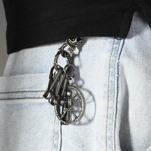 Punk skeleton skull disc pendant keychain in antique silver finish on denim jeans