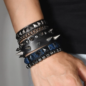 Detail of multi-layer punk bracelet set featuring spikes, studs, and heavy metal chains