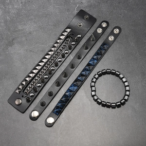 Detail of four-piece punk bracelet set with metal studs, spikes, and black faux leather