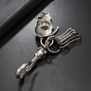 Close-up of vintage punk skeleton face metal keychain with antique silver zinc alloy finish