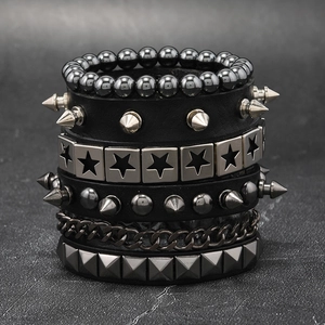 Macro view of multi-layer punk chain bracelet with leather straps and metal rivets