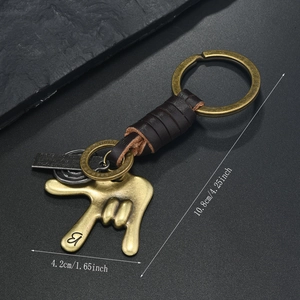 Detailed view of vintage bronze gesture pendant with woven dark brown leather strap