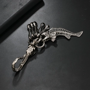 Macro shot of vintage silver skeleton fish bone keychain with metal snap hook and ring