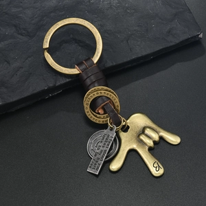 Industrial vintage alloy keychain with leather braid and bronze gesture pendant