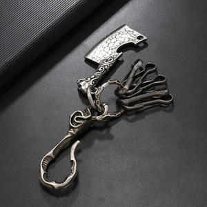 Detail of vintage silver cleaver keychain with skull buckle and four metal hooks