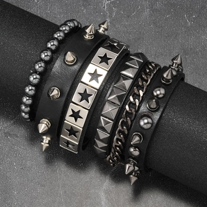 Detail of multi-layer punk bracelet with studs, metal chains, and black beads on a display