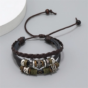Detail of multi-layer leather bracelet with metal cross charm and adjustable rope