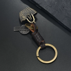 Vintage owl keychain with bronze alloy pendant and brown braided leather strap