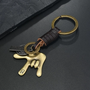 Vintage leather keychain with antique bronze hand sign pendant and metal rings
