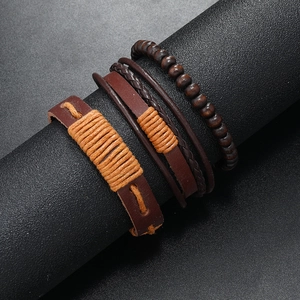 Detail of multi-layer men's leather bracelet with woven hemp rope and brown wooden beads