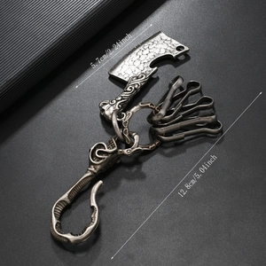 Detail showing vintage punk meat cleaver pendant and skull hook on silver metal keychain