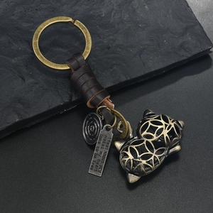 Vintage bronze cat keychain with woven leather strap and hollow gourd pendant