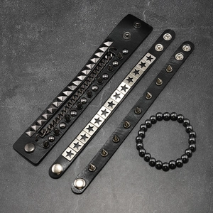 Detail of punk multi-layer leather bracelets with pyramid studs and metal chains