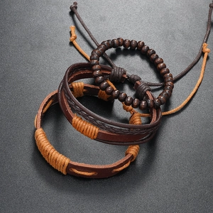 Detailed macro view of a 3-piece vintage men's leather and wood bead bracelet set