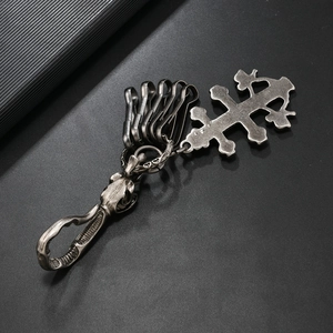 Detail of gothic silver cross keychain with multiple hooks and vintage punk finish