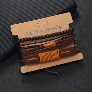 Detail of four-piece multilayer leather bracelet set with wooden beads on display card