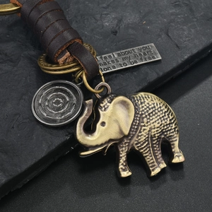Vintage bronze elephant keychain with braided leather strap and engraved metal plate