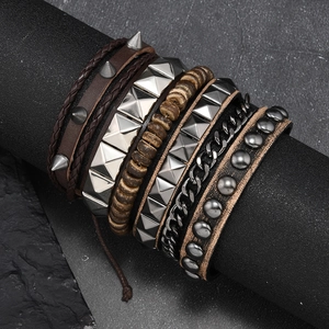 Close-up of punk multilayer leather bracelets with metal spikes and wooden beads