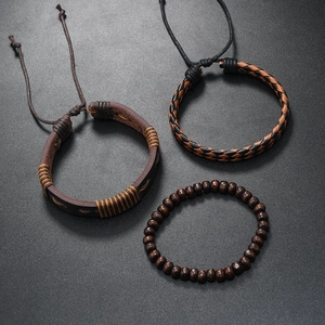 Detailed view of men's vintage leather, woven cords, and wooden bead bracelet set