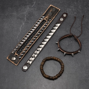 Macro detail of a 4-piece set of punk leather bracelets with studs and metal rivets