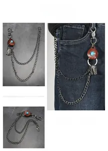Detail of hip-hop waist chain with leather drop and turquoise inlay on denim