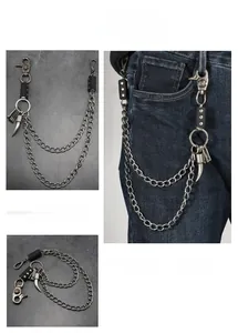 Detail of punk style double-layered metal trousers chain with skull and fang pendants