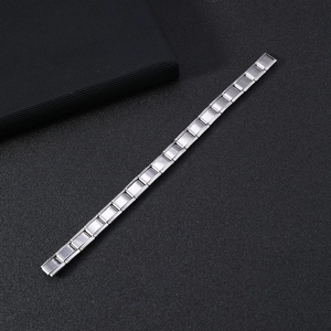 Detailed macro view of silver stainless steel modular link bracelet with matte finish