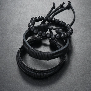 Macro detail of black braided leather multi-layer bracelet set for men with adjustable cords