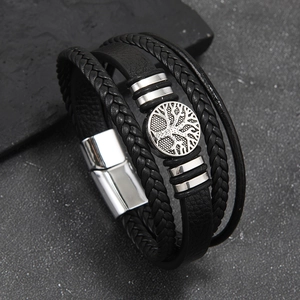 Detail of multi-layer braided leather bracelet with silver tree of life charm and magnetic clasp