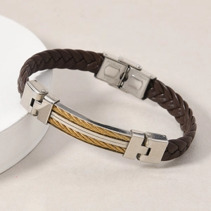 Detail of brown braided leather bracelet featuring golden steel cable inlays on metal