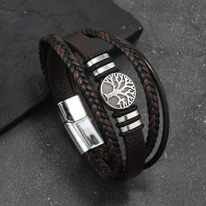 Detail showing the multi-layer leather braid and tree of life metal magnetic buckle