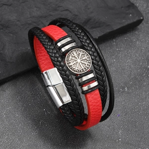 Macro detail of men's Viking compass charm on black and red braided leather bracelet