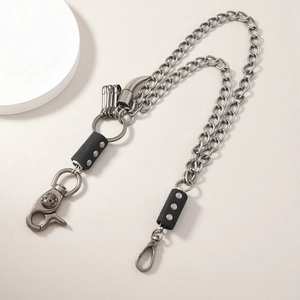 Detail of hip hop double-layer trouser chain with metallic charms and leather accents