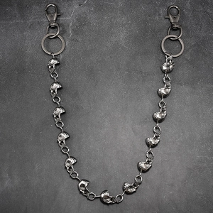 Macro detail of punk skull link chain in vintage silver metal for wallet decoration