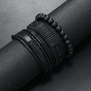 Close-up of four-piece men's black leather multi-layer bracelets with woven texture