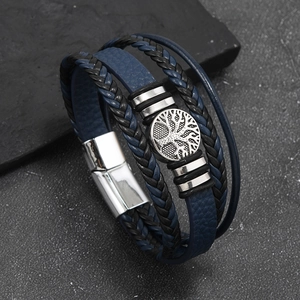 Close-up of multilayer leather bracelet with tree of life metal charm and magnetic clasp