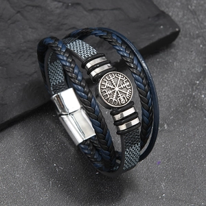 Detail of Viking Vegvisir compass charm on multi-layer braided leather bracelet with magnetic clasp