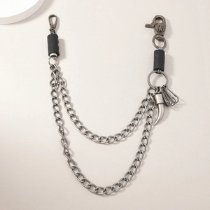 Detail of silver dual-layer pant chain with skull clasp and horn pendant accessory