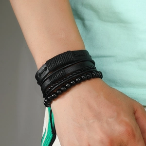 Men's multilayer black leather bracelet set with woven ropes and beaded chains on wrist