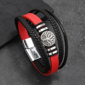Macro detail of multi-layer leather bracelet with Tree of Life charm and magnetic clasp