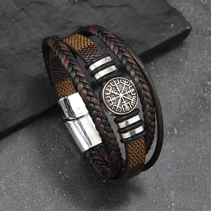 Detail of multi-layer leather braid bracelet featuring a metal Viking compass charm