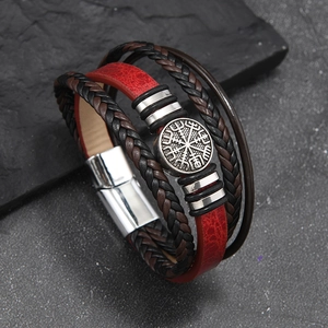 Detail of Viking compass charm on multilayer leather bracelet with stainless steel magnetic clasp