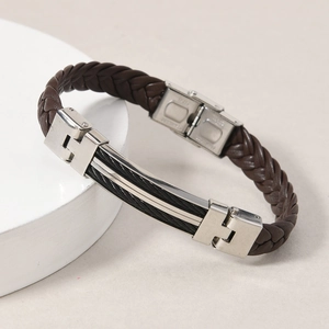 Macro shot of dark brown braided leather bracelet with stainless steel industrial detail